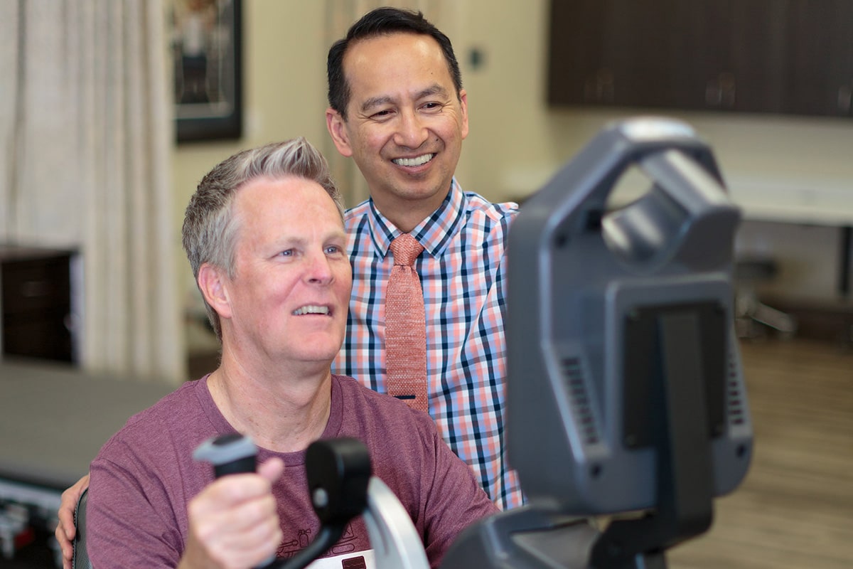physical therapist assisting an elderly resident